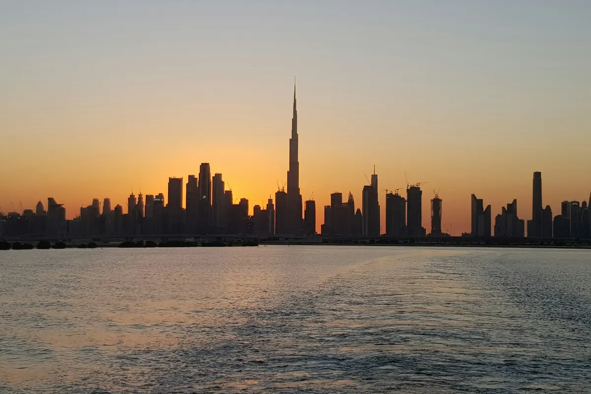 Dubai skyline at sunset across the water