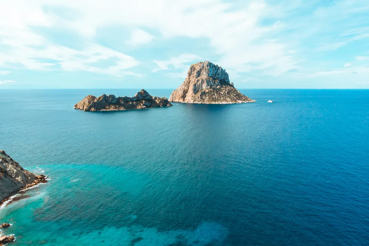 Turquoise water around the island of Es Vedra off Ibiza